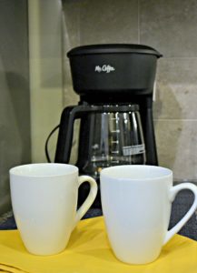 Peak Suites kitchen in luxury furnished apartment, close up of coffee pot and two coffee mugs