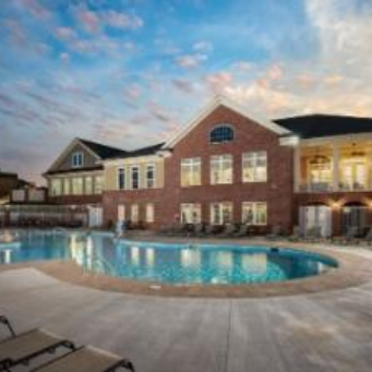 Apex Villages at Westford outdoor pool with furnished apartments building